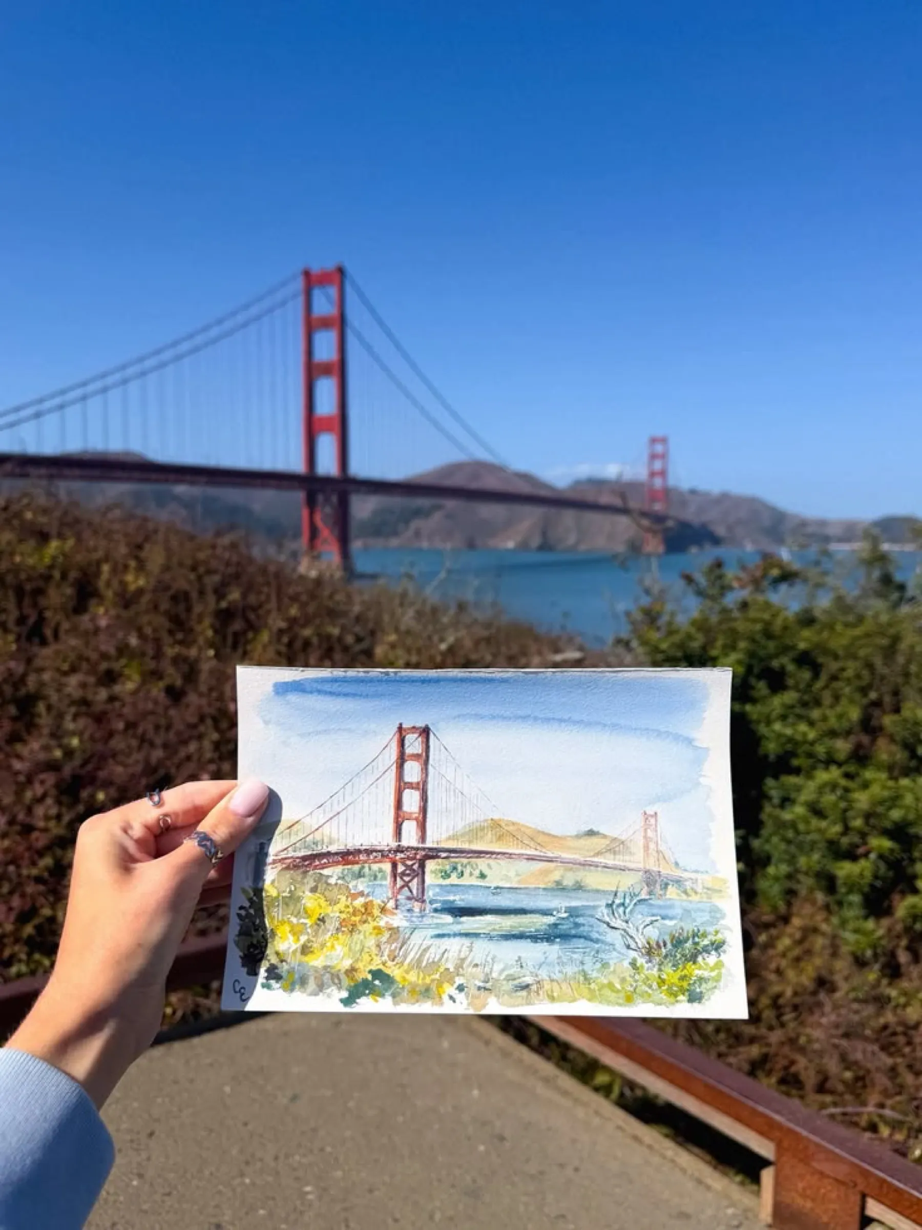 Golden Gate watercolor held up in front of the bridge